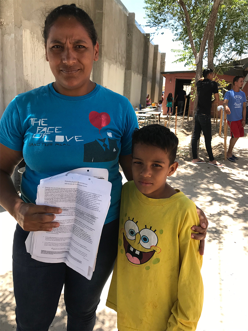 Veronica Tejeda and her 9-year-old in Juarez holding her Notice to Appear in September at U.S. immigration court. Photo by Todd Bensman