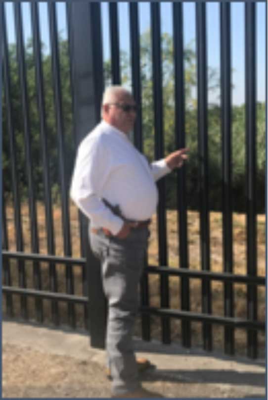 Val Verde County Sheriff Joe Frank Martinez at the border fence in Del Rio
