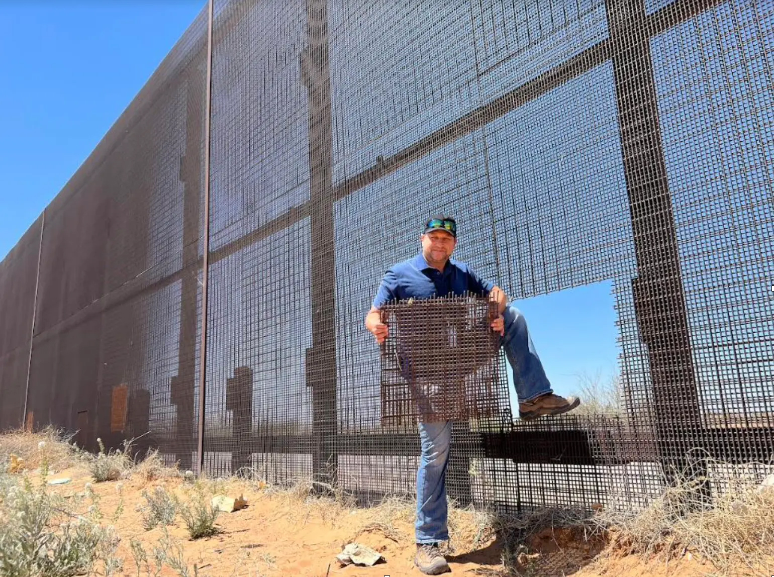Todd Bensman holds up cut up piece at the USA Mexican border