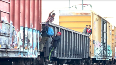 Migrants board a freight train near Monterrey Mexico in the spring of 2023